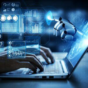 Typing on laptop with robot hand coming out of the screen.